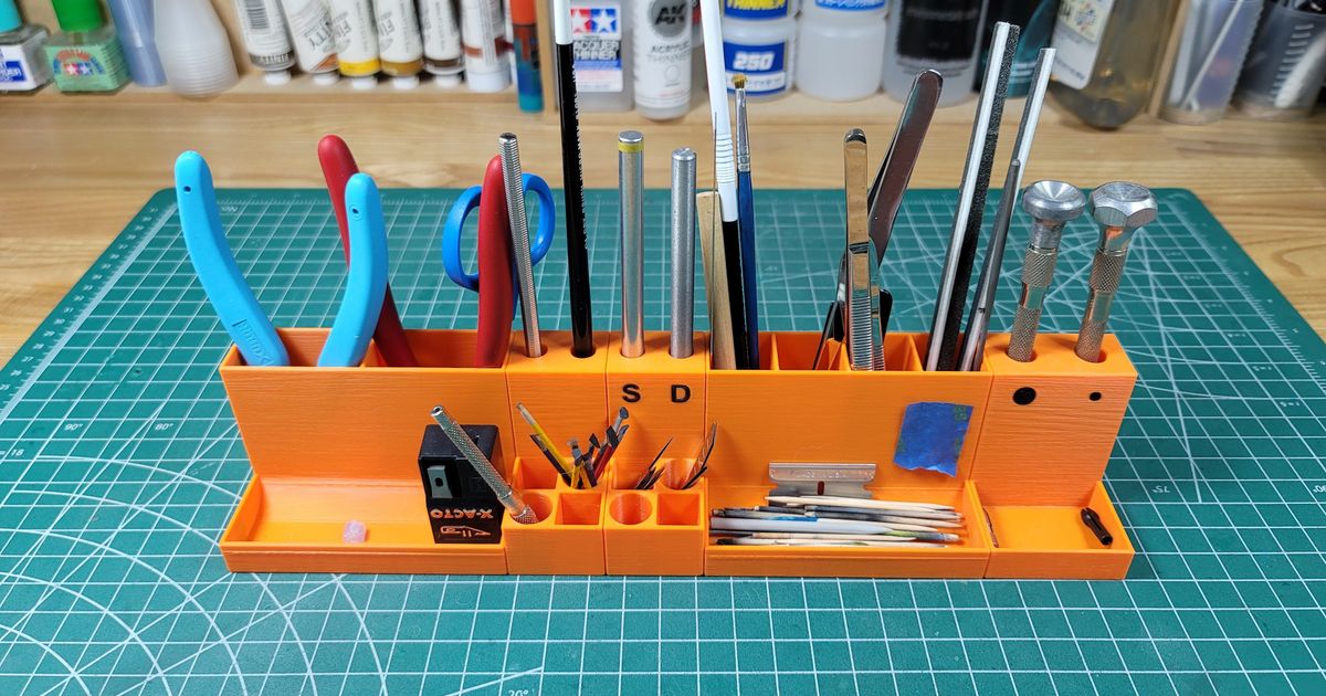 3D printed modular hobby tool holder organizing files tweezers brushes and small finishing tools on a workbench