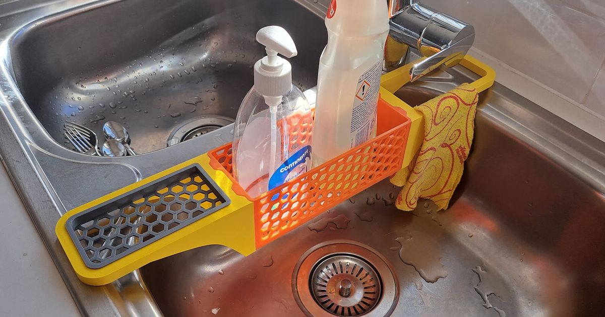 3D printed kitchen sink organizer holding soap and cleaning tools beside a sink