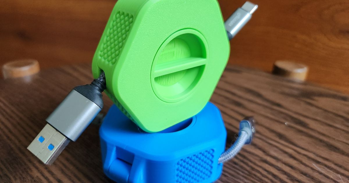 3D printed portable cable organizer winder holding a charging cable in a compact travel-friendly form