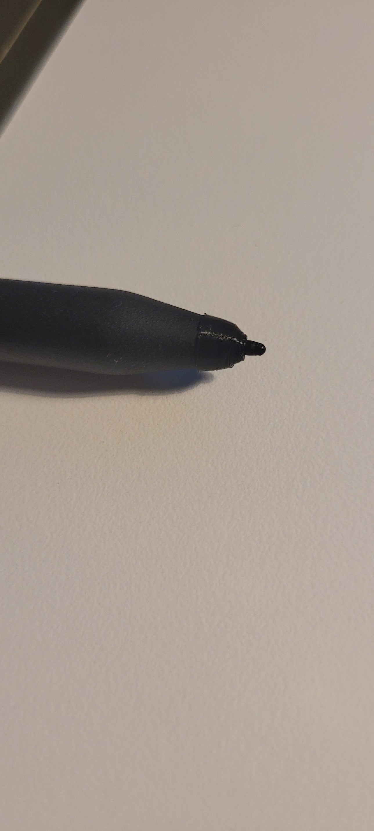 3D printed reMarkable pen tip support replacement next to a damaged digital stylus tip area