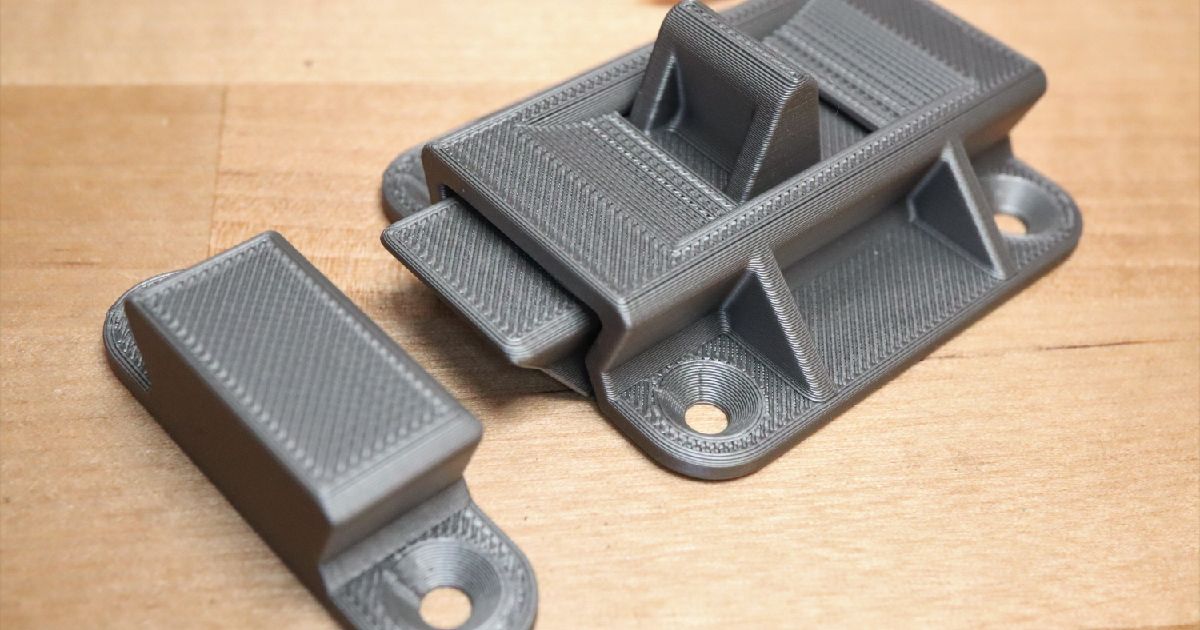 3D printed spring loaded slide bolt latch mounted on a small door or panel for a simple printed closure system
