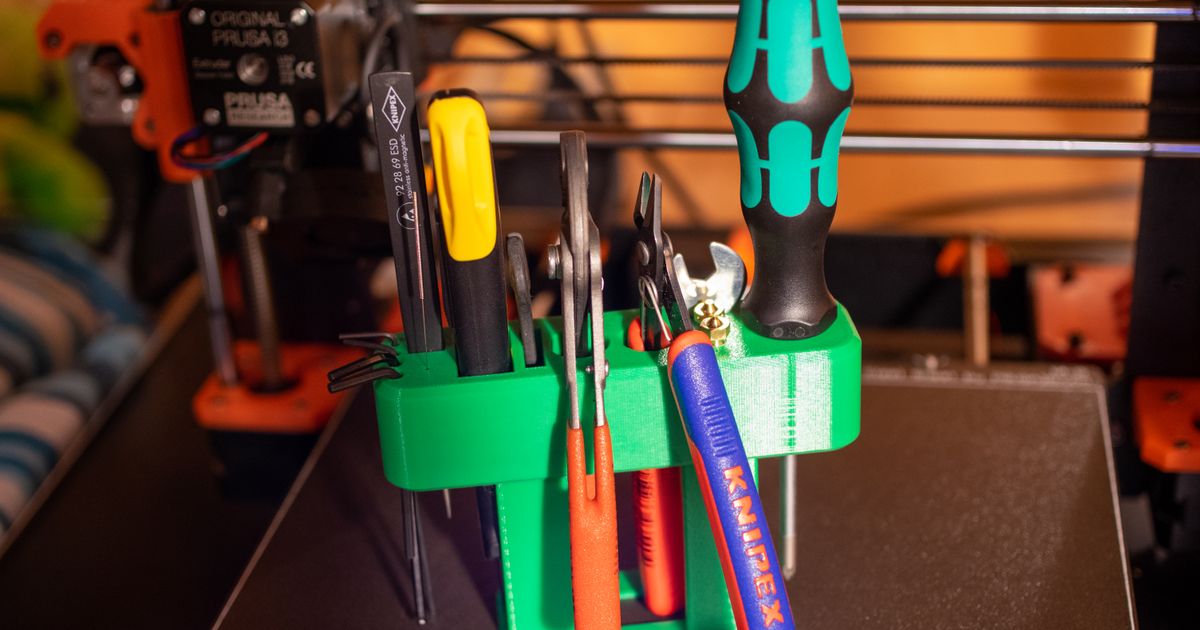 3D printed tool organizer holding pliers, screwdrivers, and workshop hand tools