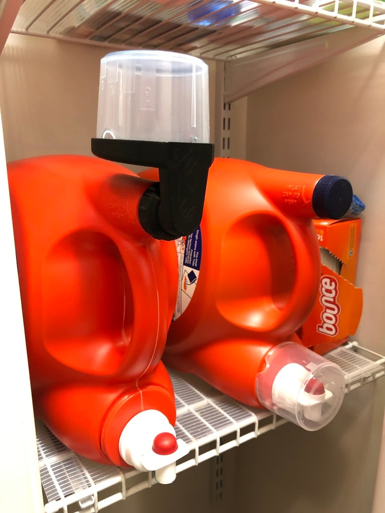 3D printed laundry detergent cup drain mounted on a detergent bottle to catch drips and return soap to the jug