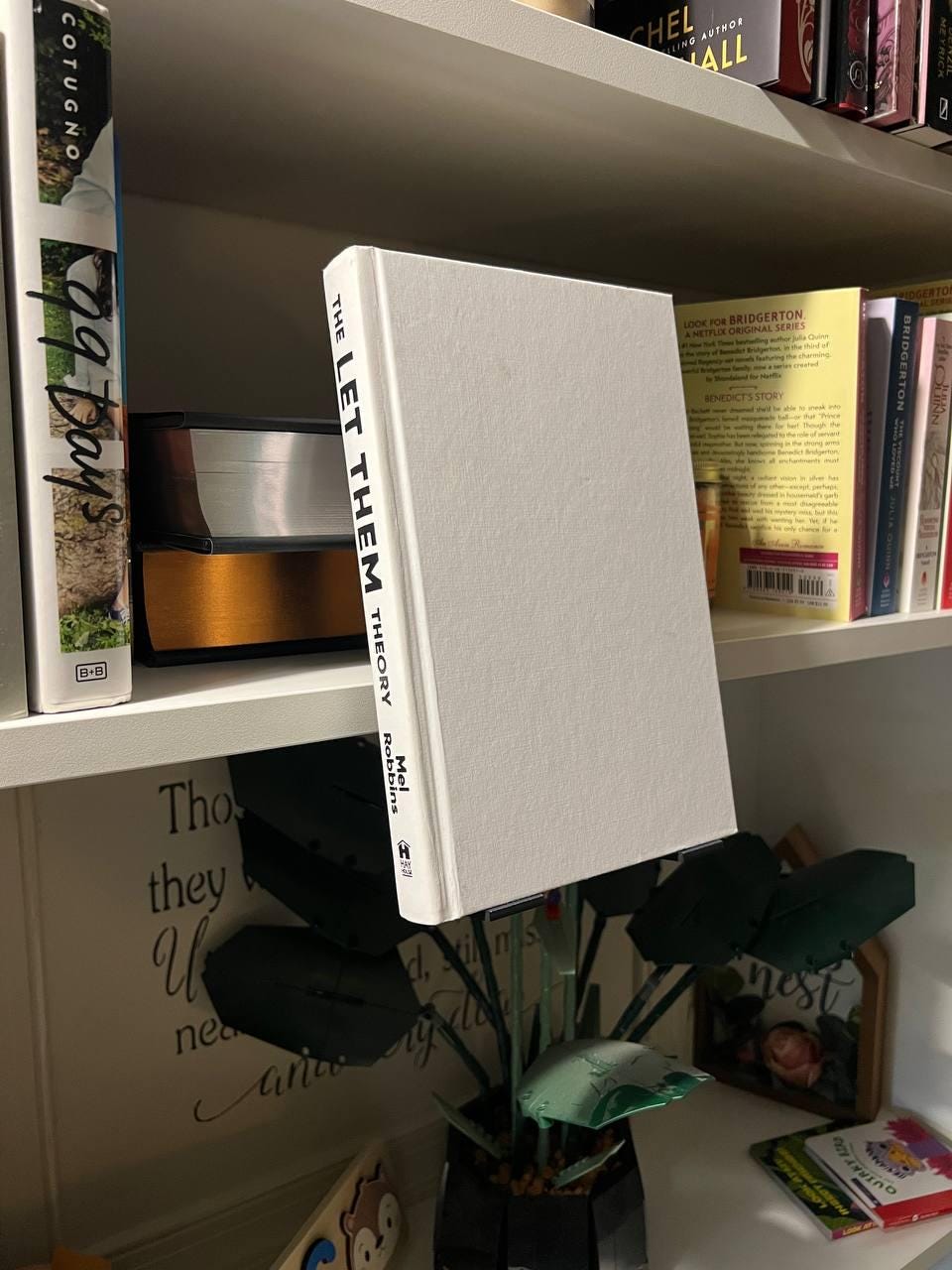 JCSFY floating book display clip installed on an IKEA Billy shelf with a book shown forward on the front ledge.