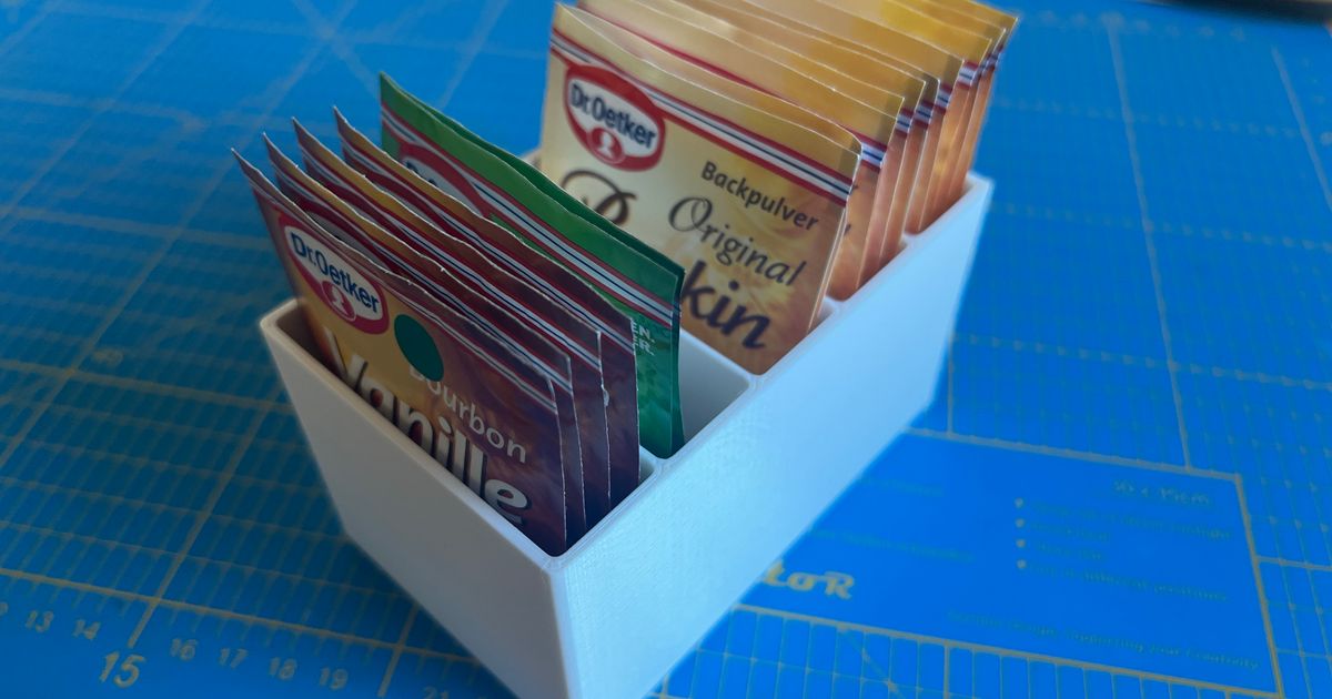 3D printed kitchen packet organizer storing baking and seasoning packets upright inside a cabinet
