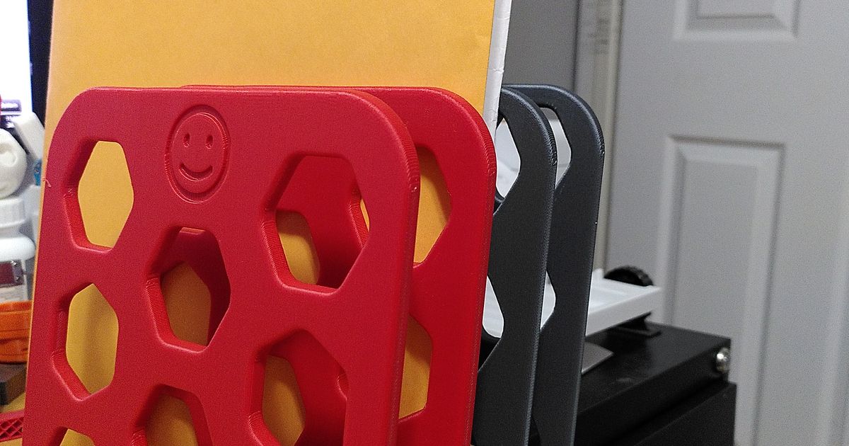 3D printed vertical file folder organizer on a desk holding papers and folders upright