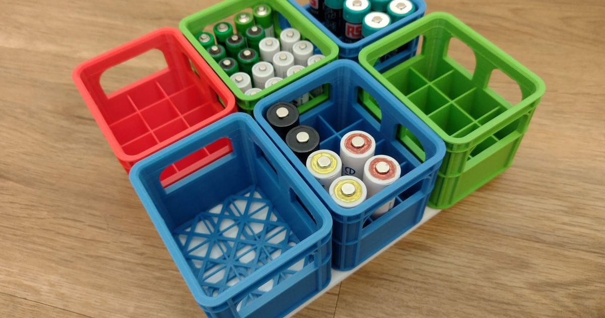 Stackable 3D printed battery crates holding mixed battery sizes on a shelf