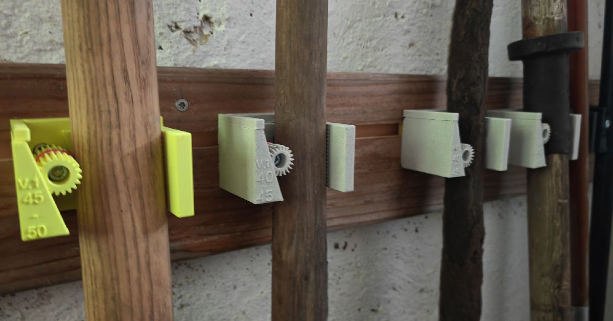 3D printed modular gravity tool holder system mounted on a wall for brooms, mops, and long-handle tools