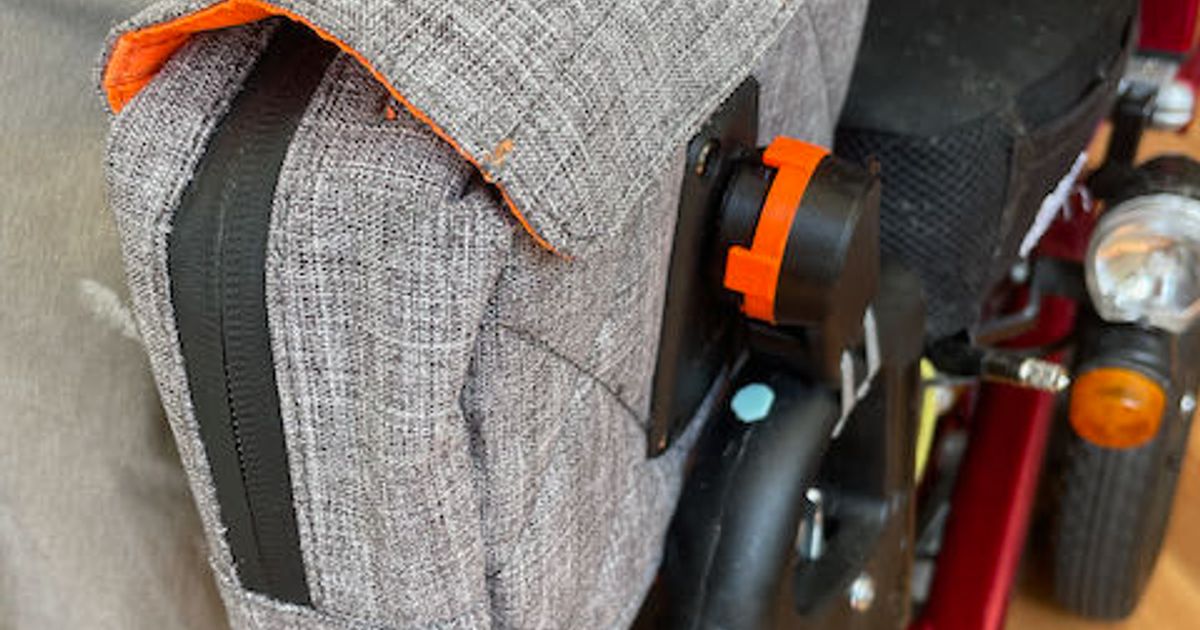 3D printed wheelchair bag mounting system attached to a wheelchair frame with a storage bag installed