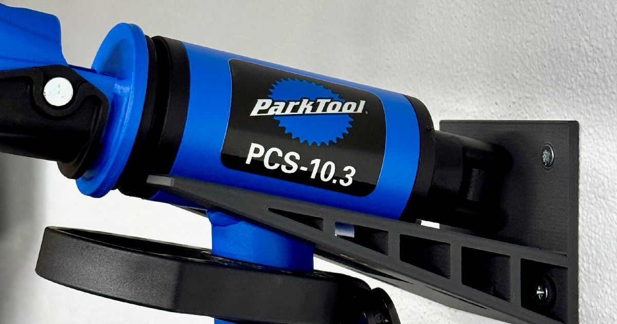 3D printed wall mount holding a folded Park Tool PCS 10.3 bike repair stand