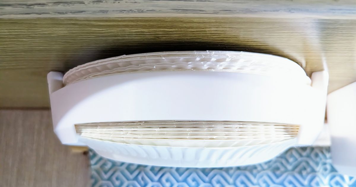 3D printed undermount paper plate dispenser installed under a cabinet