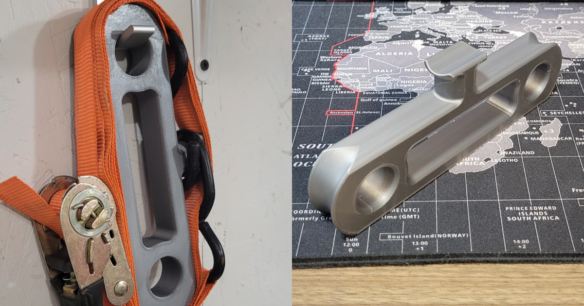 Ratchet strap organizer holding a wound tie-down strap for cleaner trailer and garage storage
