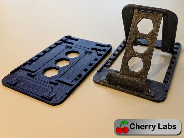 3D printed flat-fold phone and tablet stand shown opened and folded for compact storage