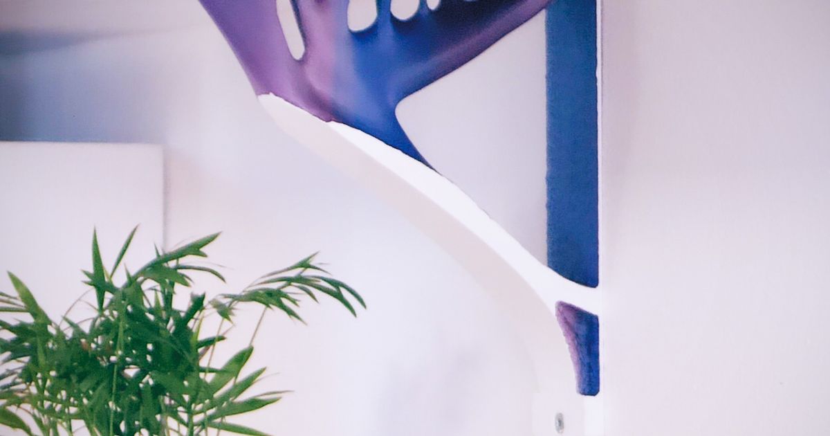 3D printed topology optimized shelf bracket mounted under a shelf board for workshop or utility-wall storage