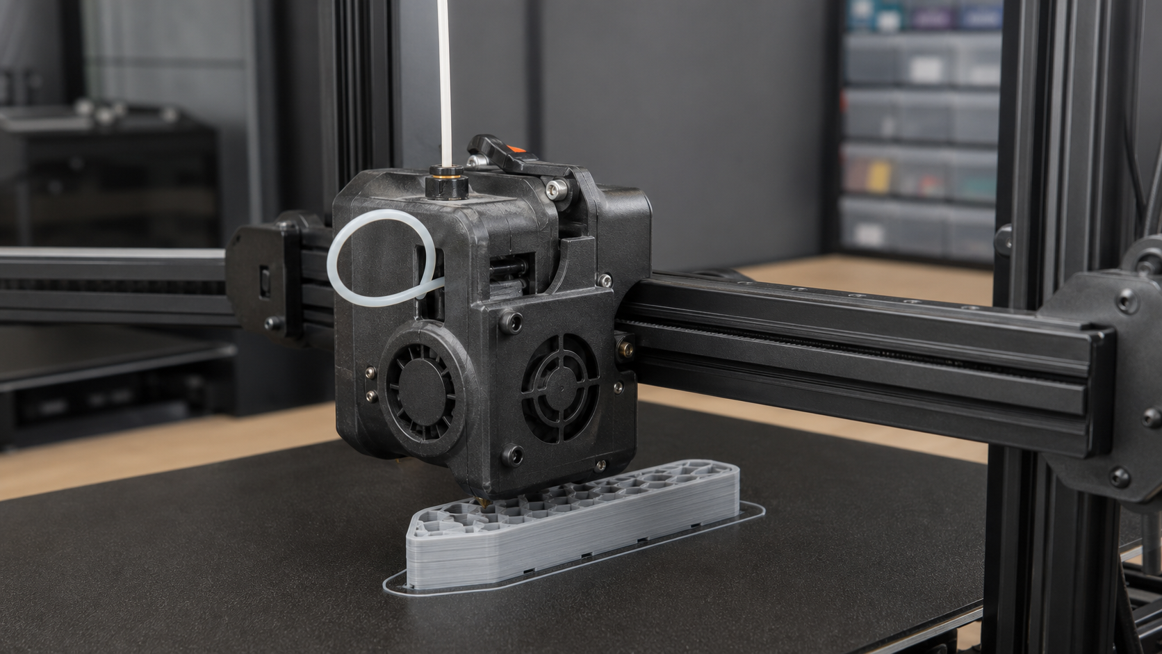 Flexible TPU filament buckling into a loop beside a direct-drive 3D printer extruder during a paused print.